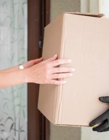 close-up-courier-delivering-package_23-2148593070